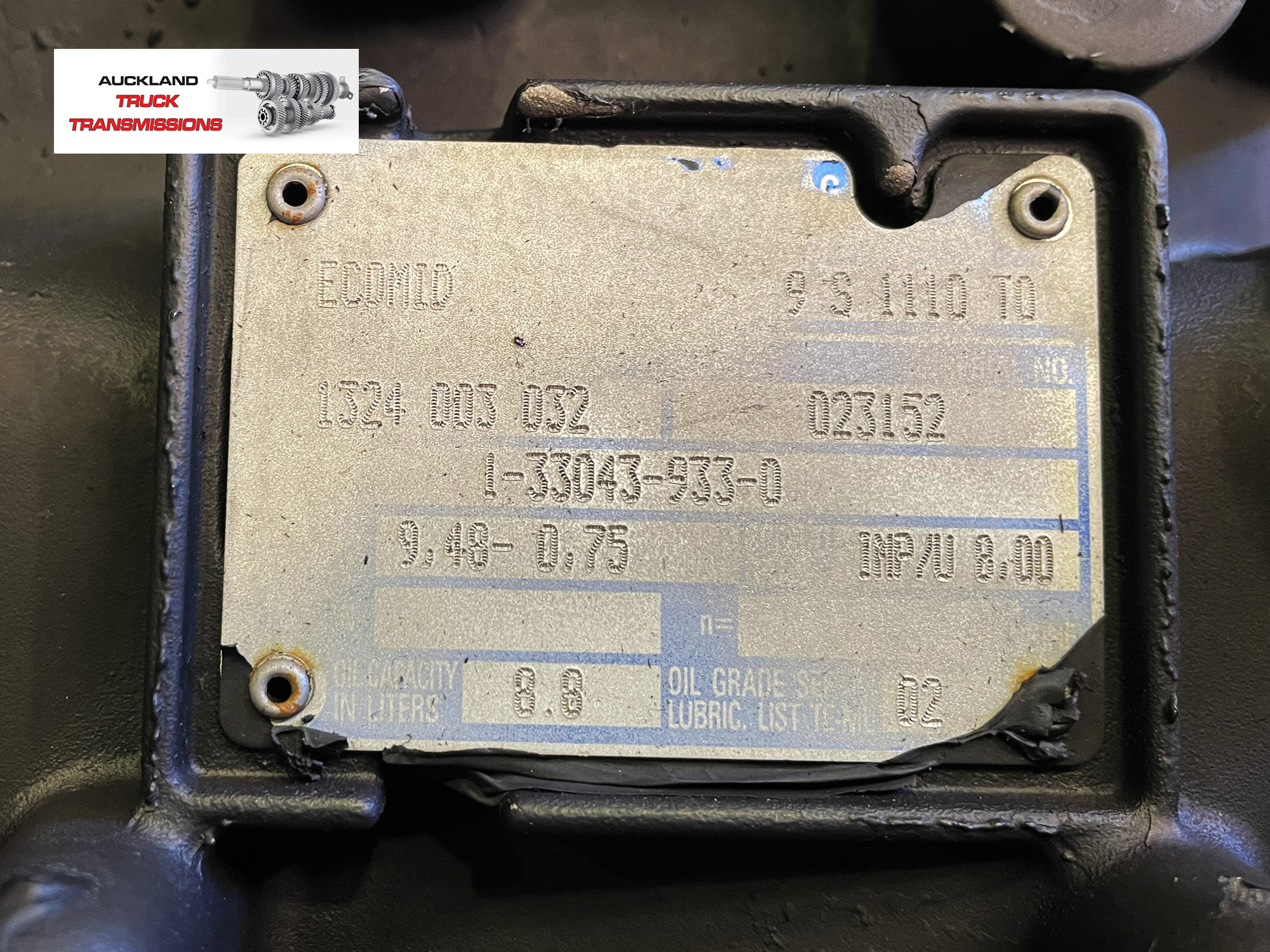Close-up of gearbox information plate.